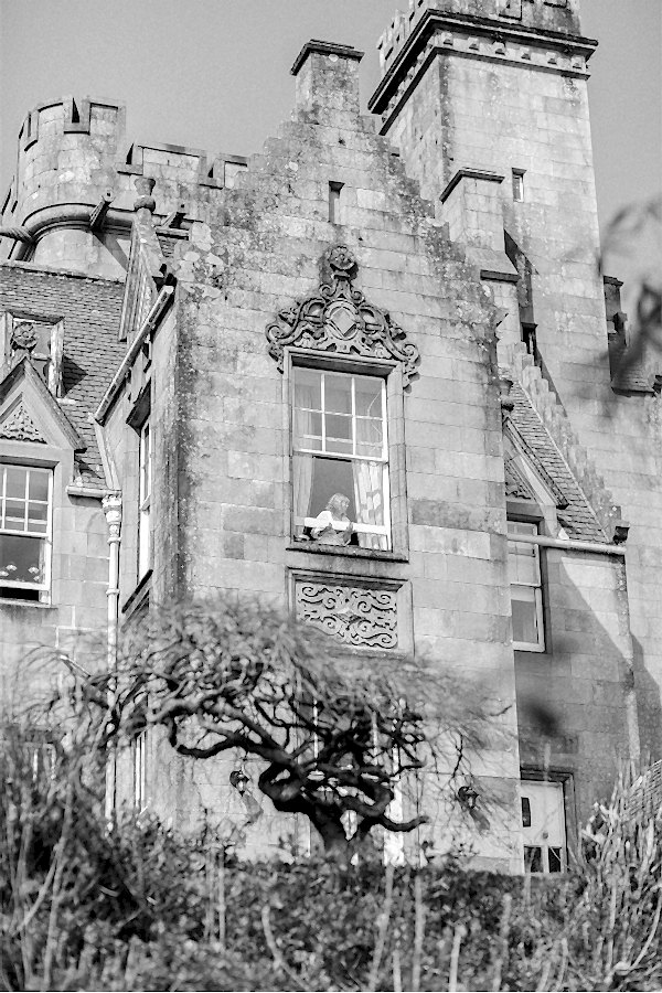 bride opening a window at stonefield castle scotland