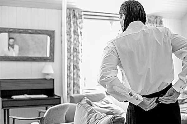 groom fixing his kilt during preparations