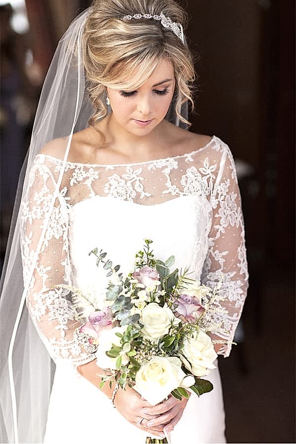 bride looking at her flowers at stonefield castle