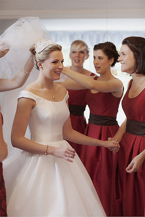bridesmates helping to fix bride