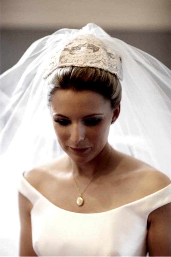 bride looking down having her veil fixed