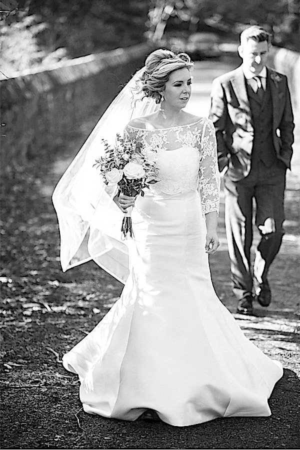bride walking away at a bridge at stonefield castle