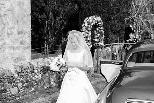 bride walking towards church at wedding