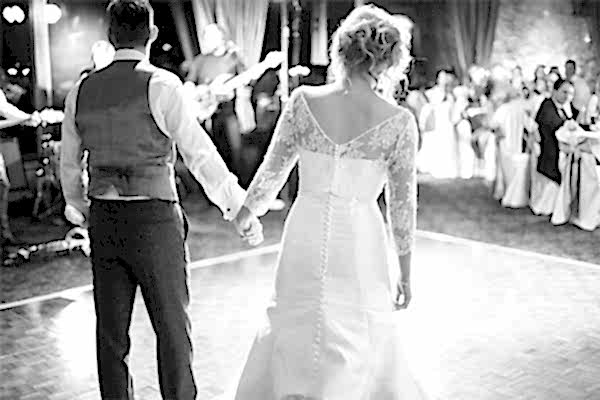bride and groom walking in into their wedding first dance