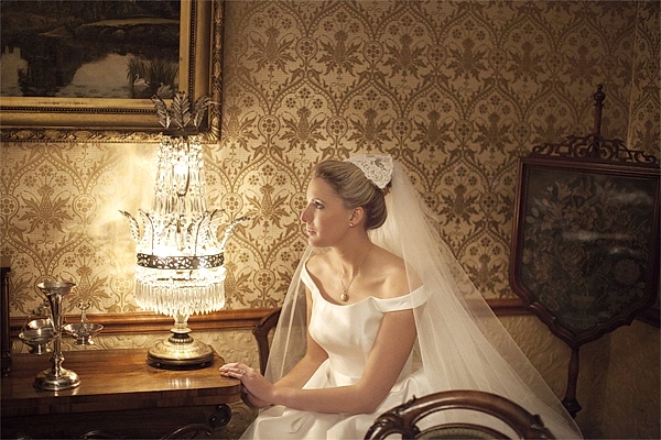 bride nxt to a vintage lamp