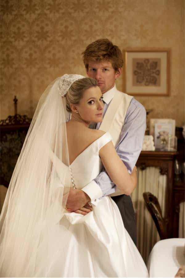 bride and groom embraced at home after wedding ceremony