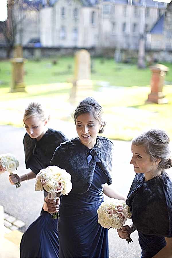 bridemsates going into teh church wearing navy blue dresses
