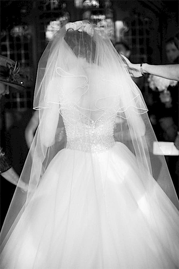 girls fixing brides dress just before ceremony