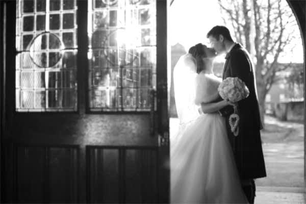 newlyweds kissing embraced