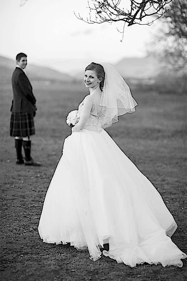 bride and groom standing at loch lomond