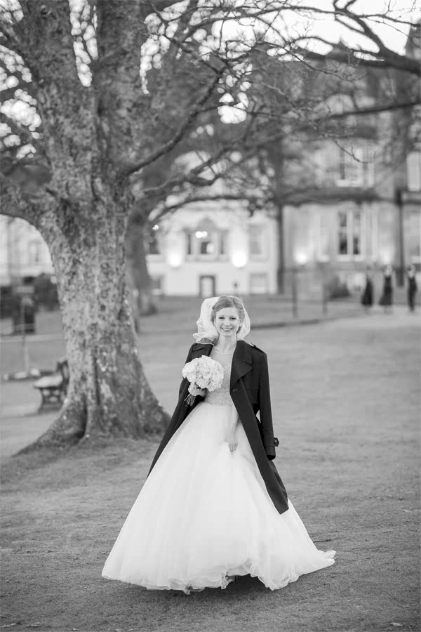 bride in a winter coat during wedding photo shoot