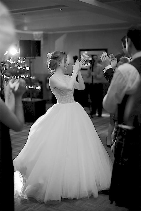 bride laughing and claping after first dance
