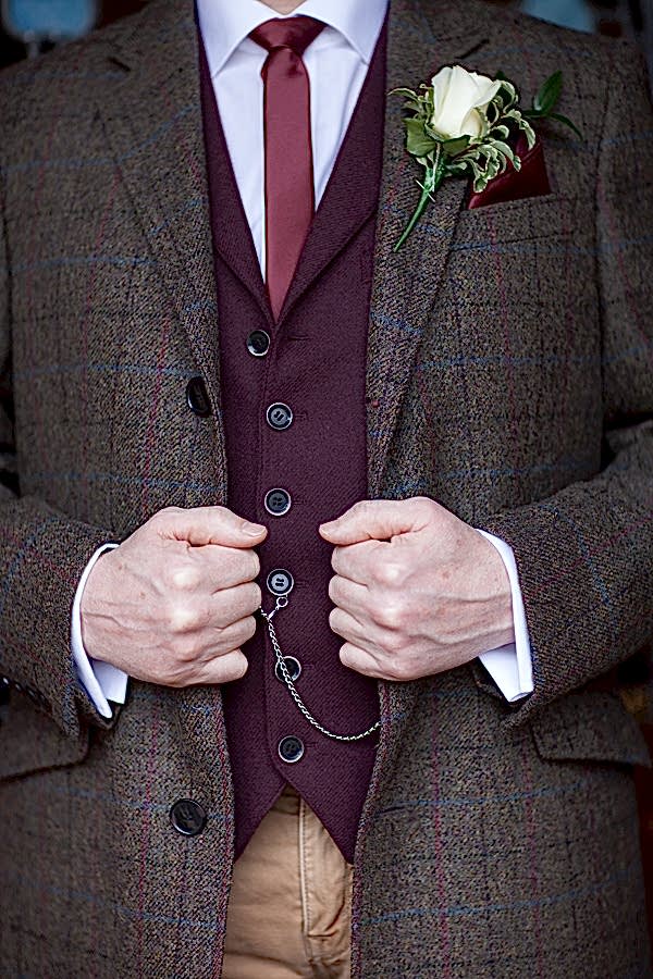 groom holding his suit the lodge on loch goil scotland