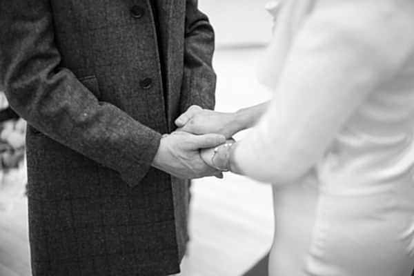 bride and groom holding hands