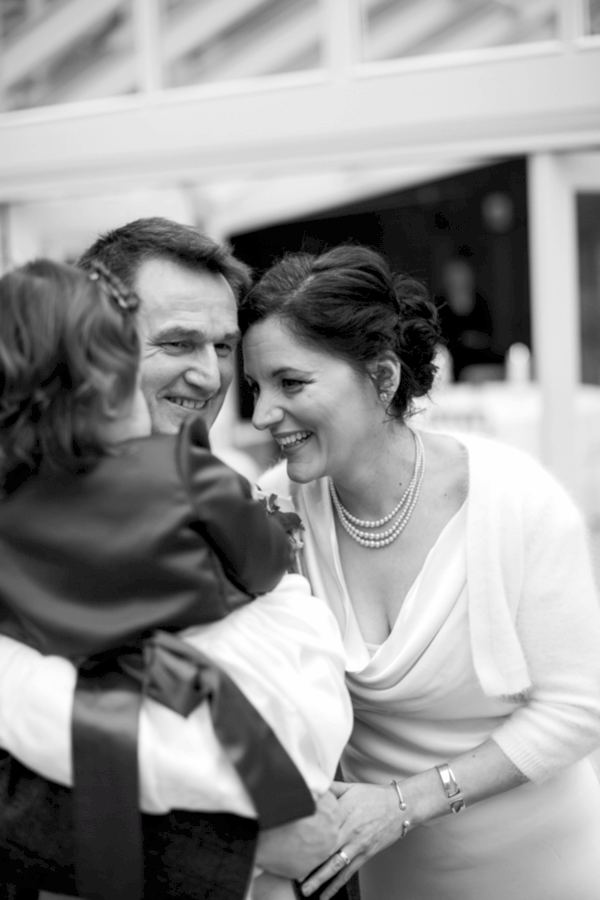 bride and groom and their daughter during ceremony