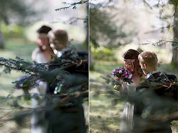 view through trees at bride and groom