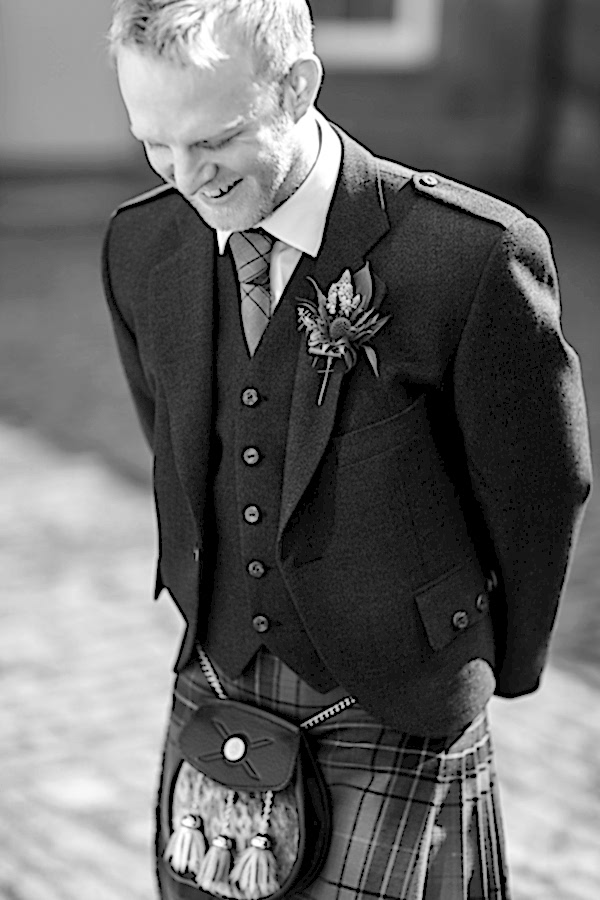 groom looking down dressed in scottish kilt