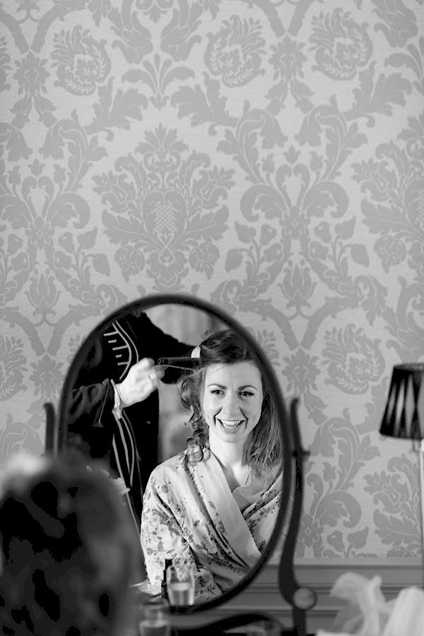 bride having her hair done during preparations at  blairquhan castle
