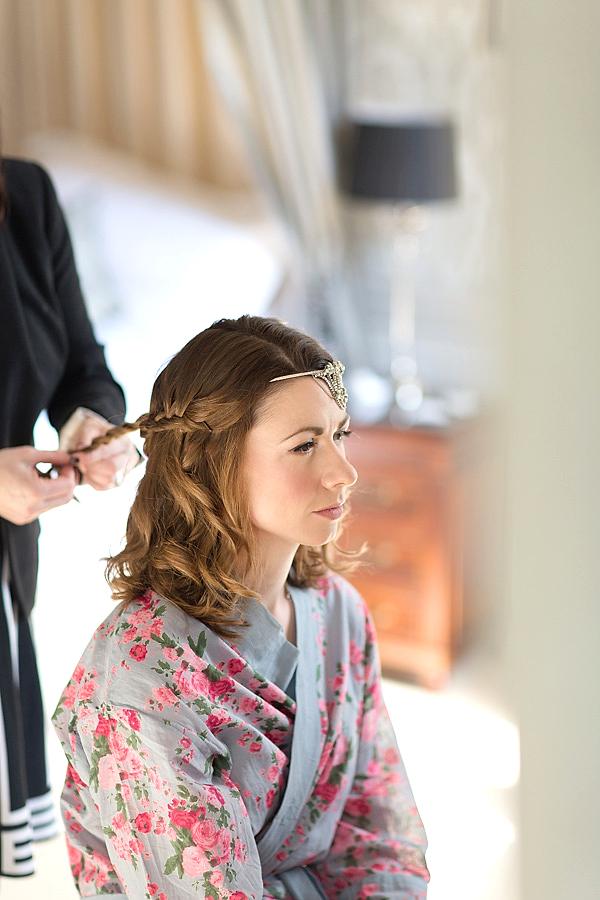 bride having her hair done and hair piece installed