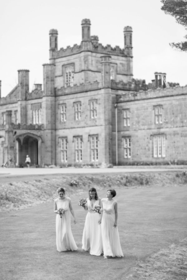 wedding photos bridesmates walking with Blairquhan Castle in the background
