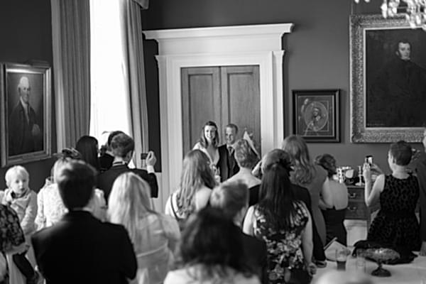 wedding guests taking photos of bride and groom