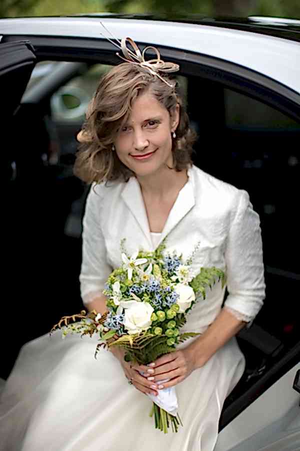 bride smiling getting out of the car