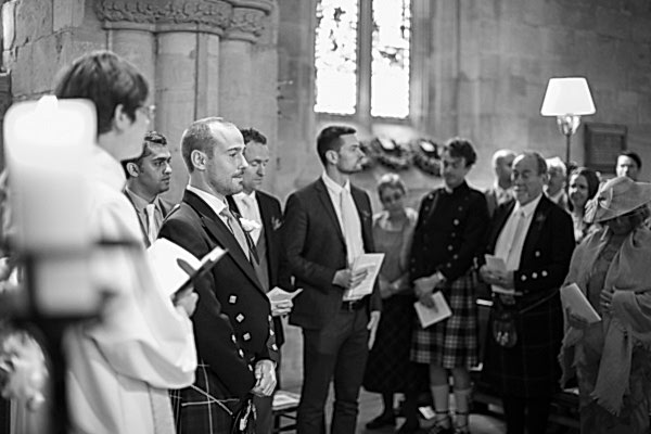 groom and guests waiting for teh bride at church ceremony