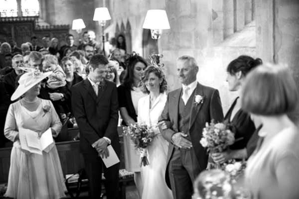 bride walking down to church ceremony