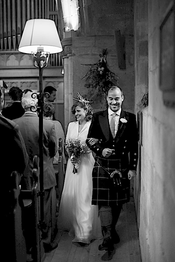 newlyweds walk out of the church near edinburgh