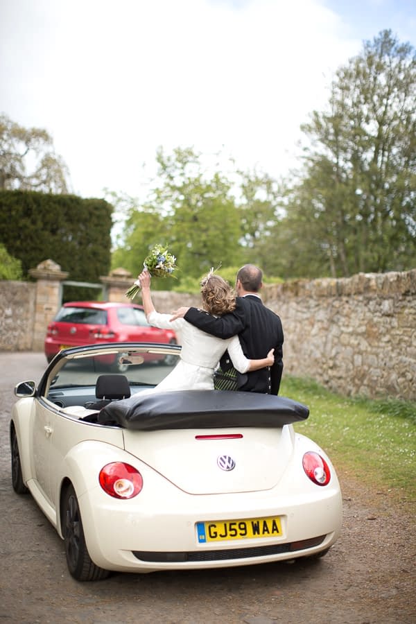 newlyweds driving away in a VW beattle in edinburgh scotland