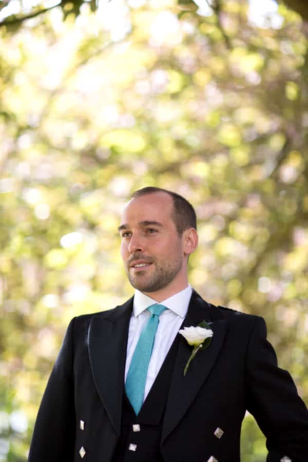 groom looking away with flower botton hole