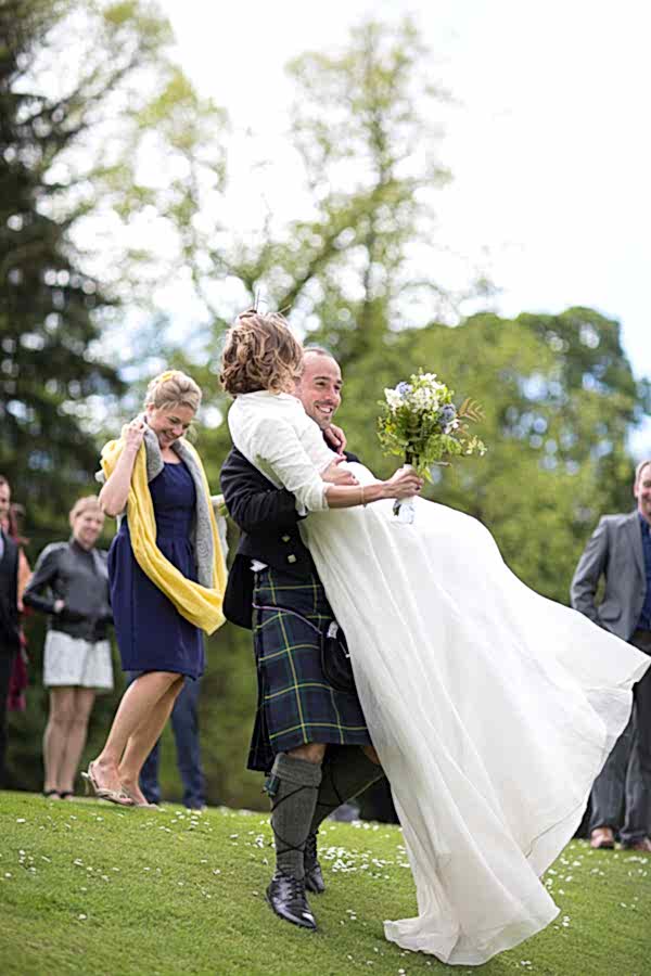 wedding photographer edinburgh scotland groom lifting bride