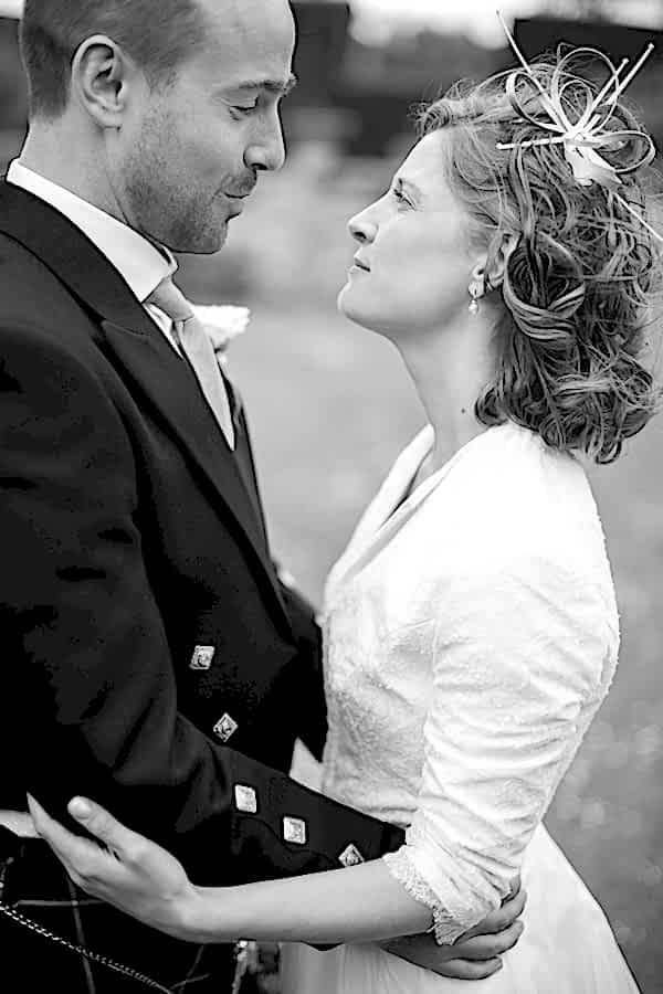 wedding photographer edinburgh bride and groom looking at each other embraced 