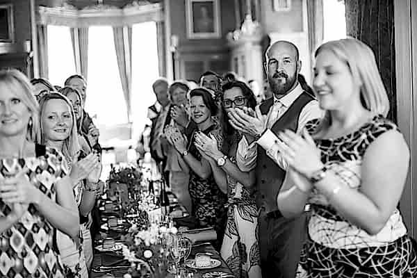 guests clapping looking at bride and groom