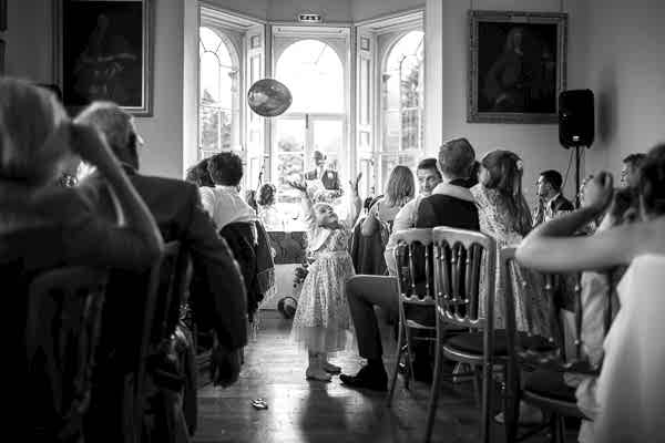 girl playing with baloon during wedding speeches