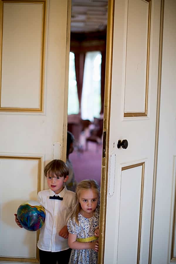 kids looking in from behoind closed doors