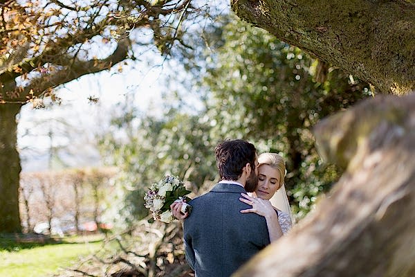 bride and groom embraced in the garden 
