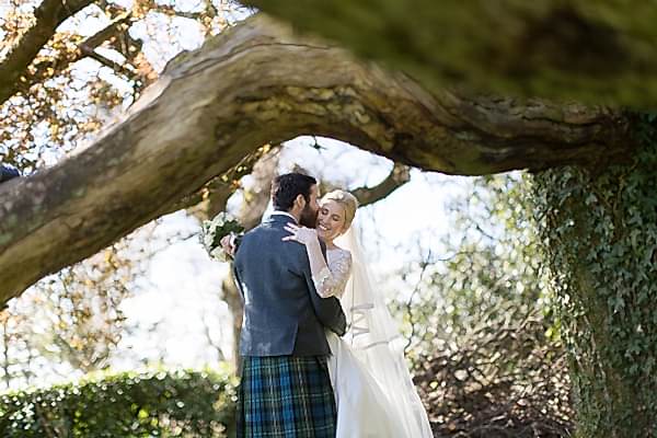 married couple embraced wedding photos loch lomond