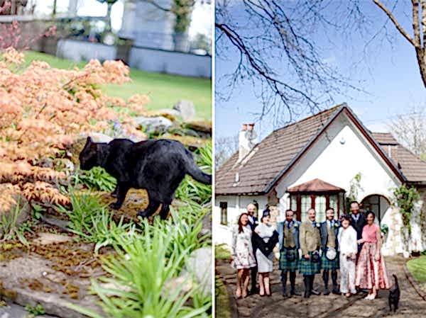 family photo infornt of a house with cat