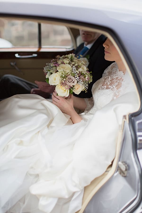 bride and father insdie the wedding car at church ceremony