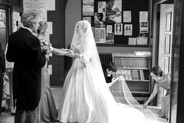bride holding hands with bridesmate just before ceremony