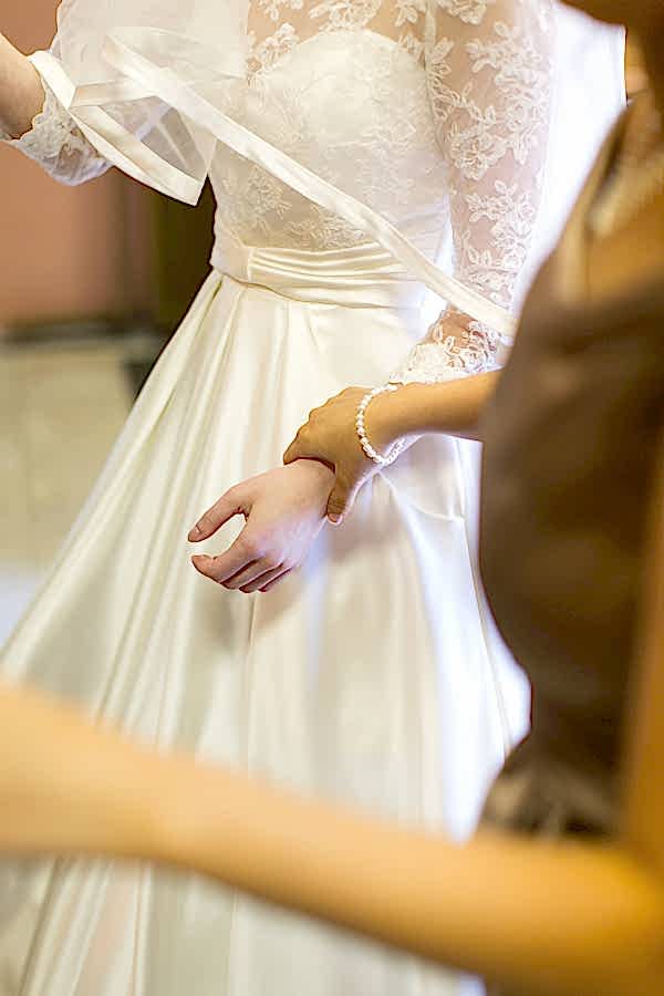 bridesmate holding bride
