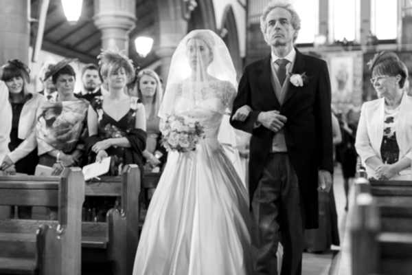 bride walking down at a large church ceremony