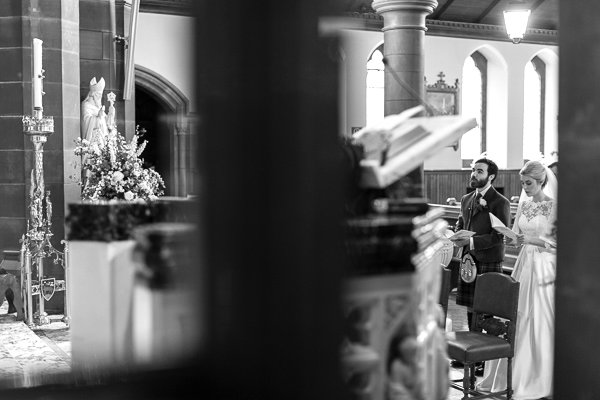 bride and groom singing in church