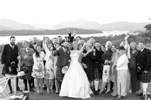bride and groom with guests outside