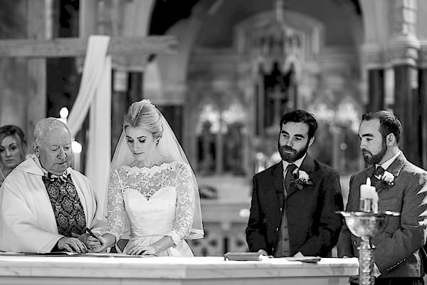 bride signing the register at church ceremony in scotland