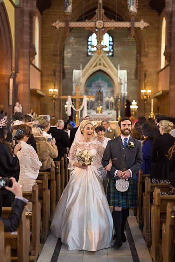 bride and groom laughing walking
