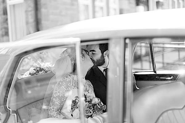 newlyweds in the car kissing