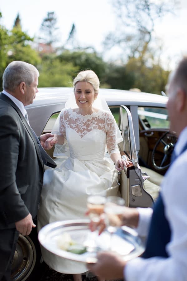 bride stepping out of teh car at the castle scotland