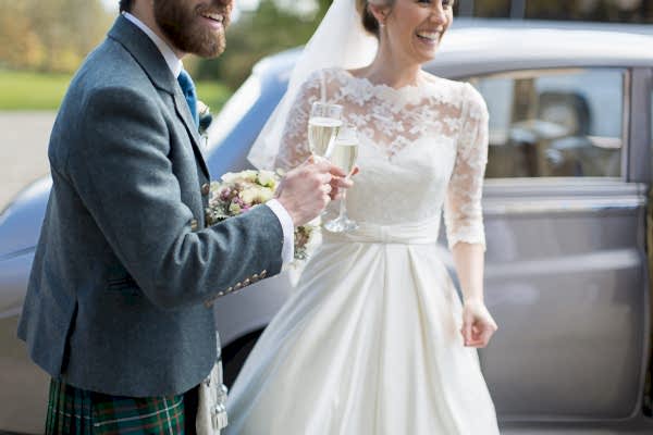 champagin in hands bride and groom